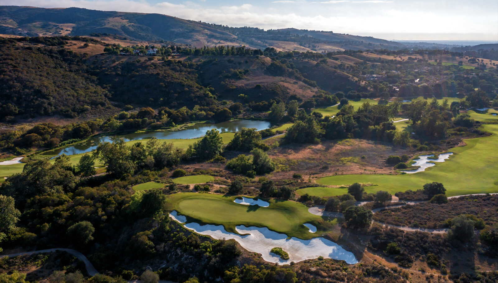 Aerial view of the golfing green surrounded by majestic hills