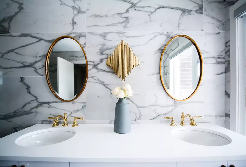 Double Sink Vanity with Marble Finish and Gold Framed, Round Mirrors Above