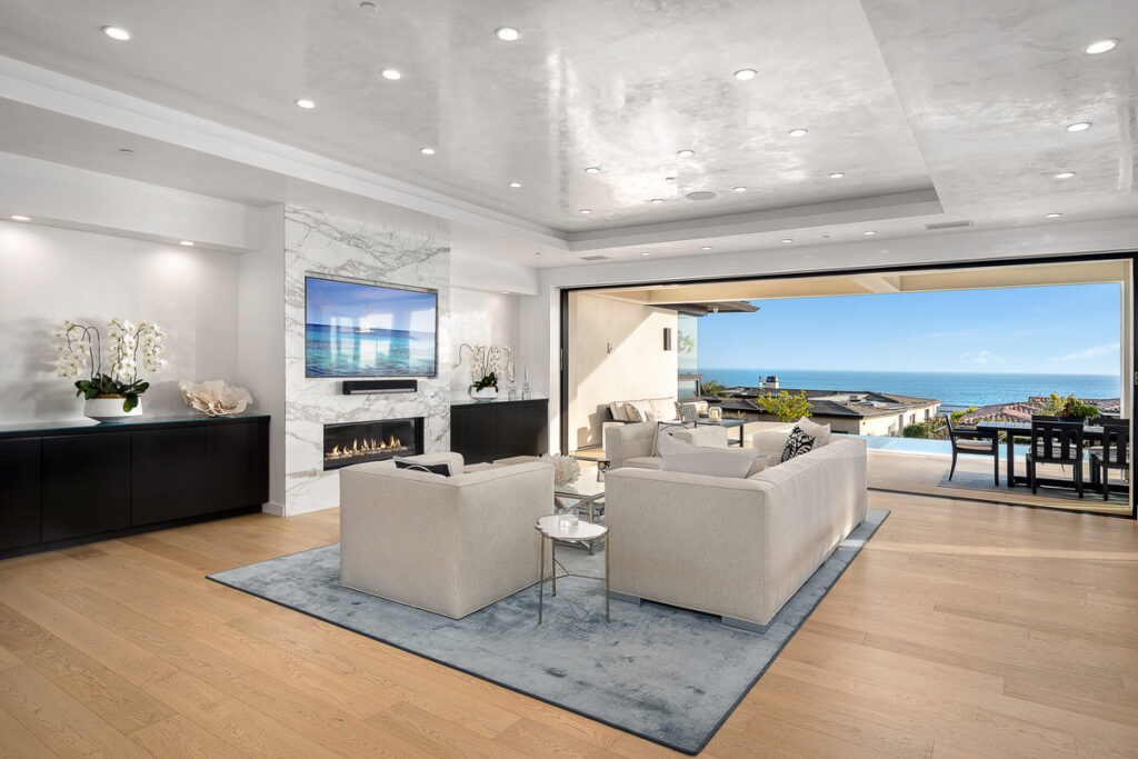 Elegant living room in a Cameo Shores luxury home with bifold doors opening to the pool and ocean