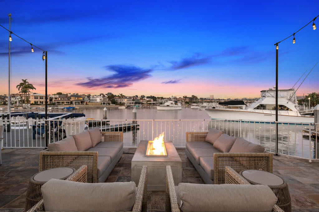 Waterfront patio with fire pit and seating area on Balboa Island