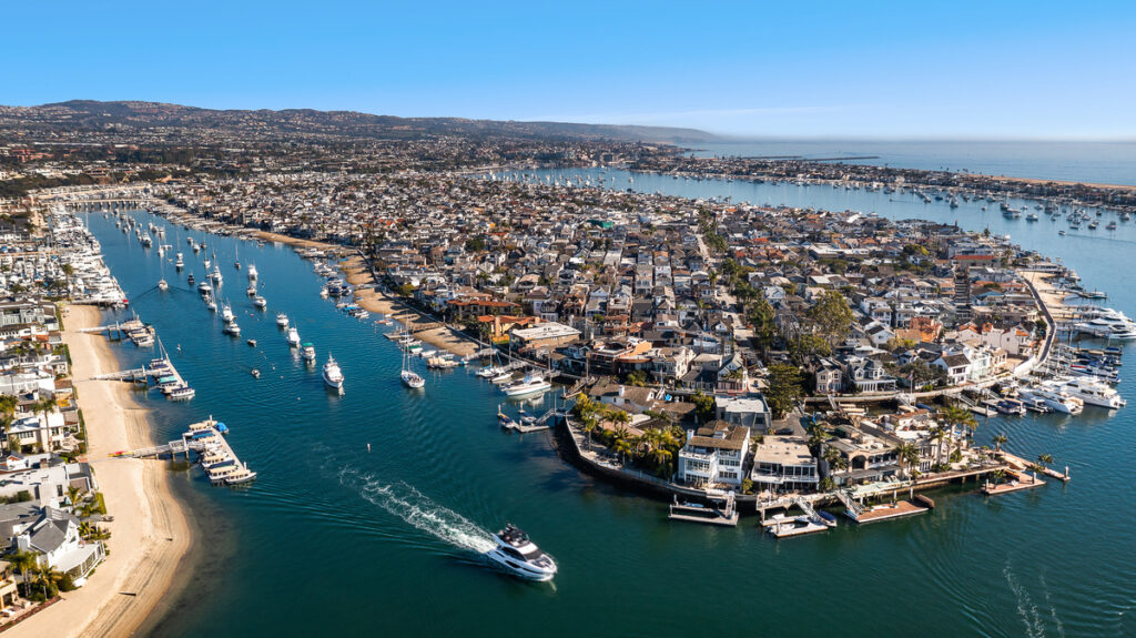 Aerial view of Balboa Island homes and boats in Newport Harbor