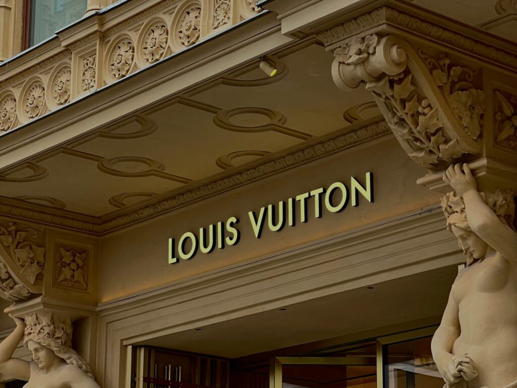Louis Vuitton store logo on a building with intricate carved details