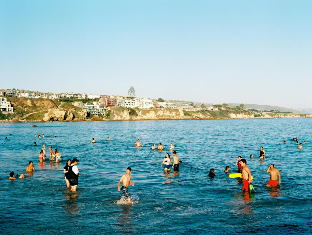 People enjoying the beach and ocean in Newport Beach, California