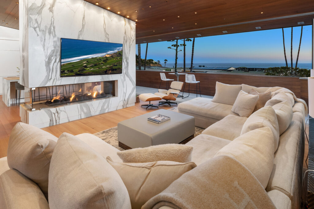 Luxury home living room with panoramic windows overlooking Laguna Beach and the Pacific Ocean