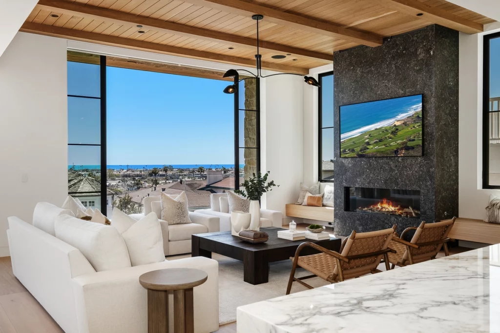 Living room of Newport Beach luxury home with fireplace and patio