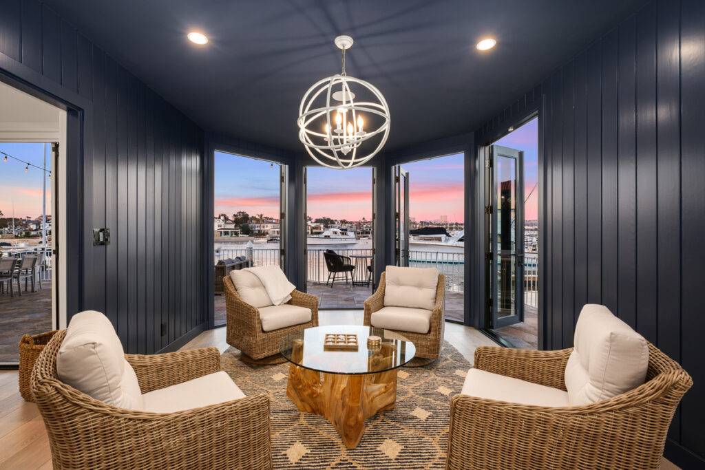 Living room with bay windows overlooking Newport Beach real estate top luxury agent realtors