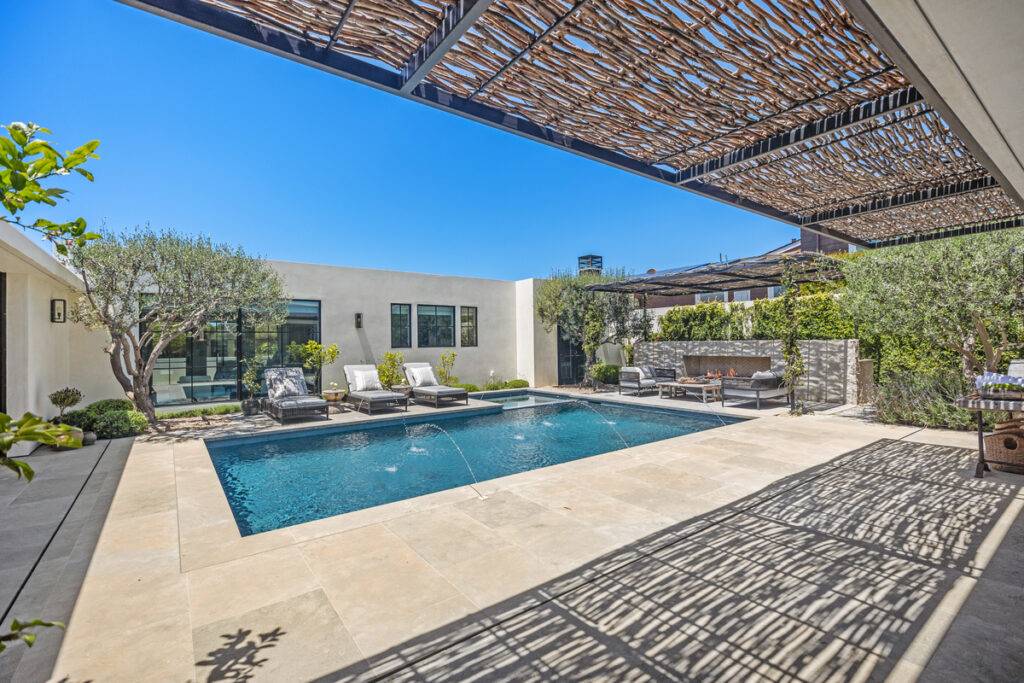 Outdoor living space and pool of an Orange County luxury home sold by Andy Stavros top listing agent.
