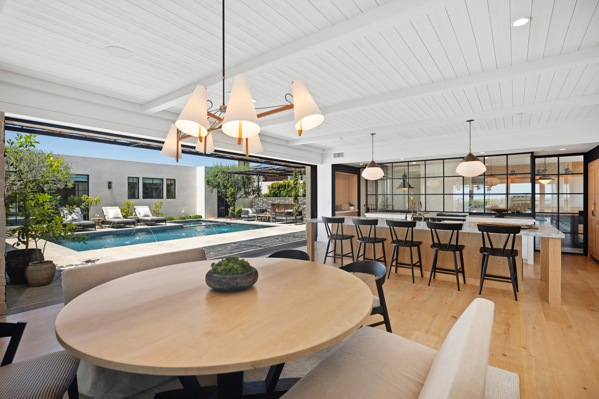 Luxury interior design in Orange County home with kitchen island and light wood finishes by top luxury real estate agents Stavros Group