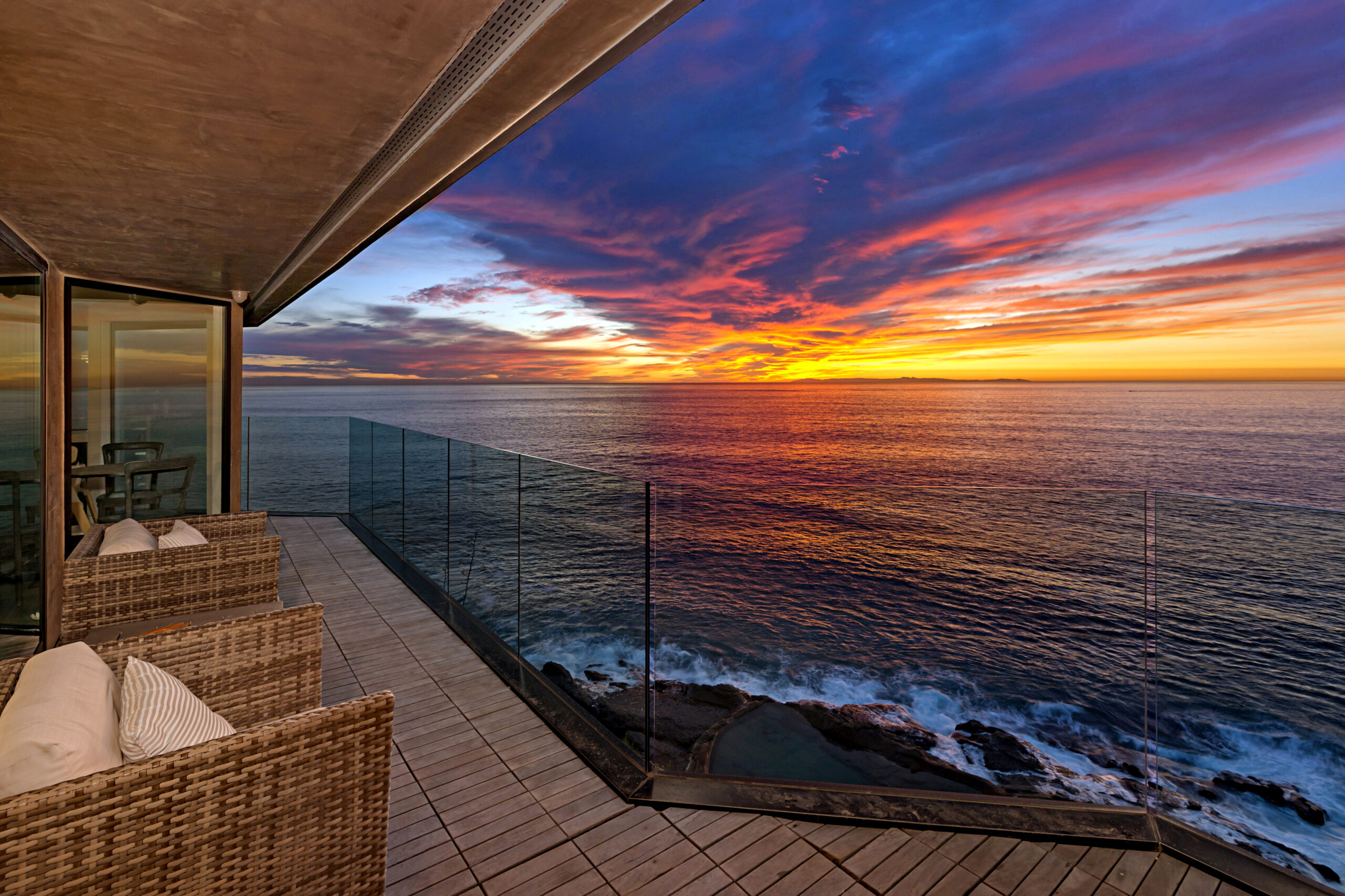 Luxury home selling in Laguna Beach with ocean views at sunset by top local listing agent Andy Stavros Group
