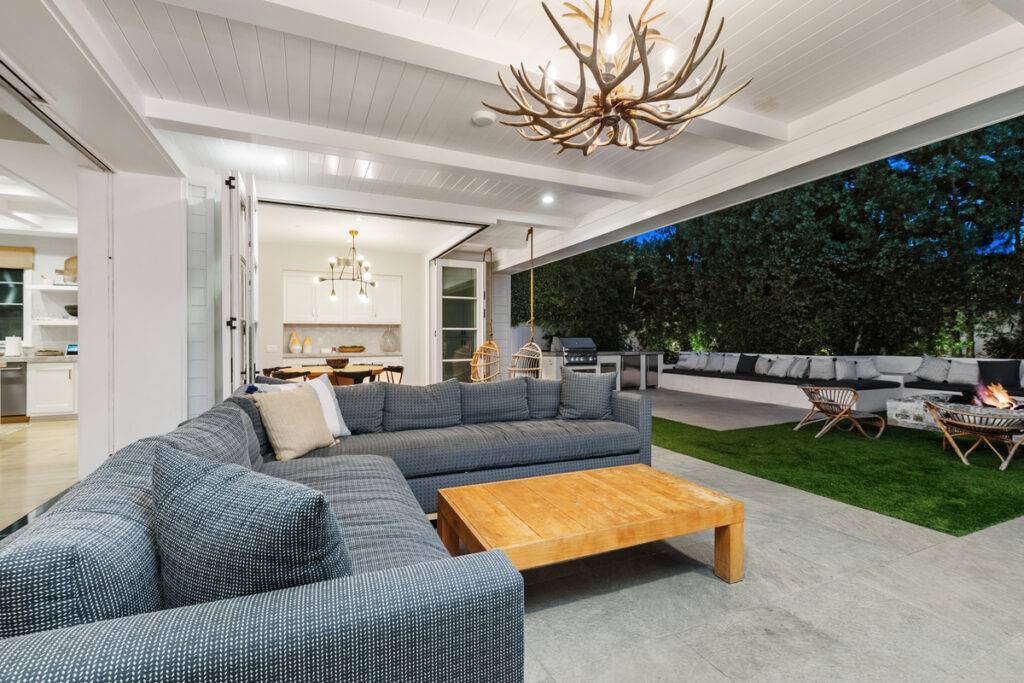 Outdoor California room with fireplace and patio of home selling with Stavros Group top luxury agents in Newport Beach