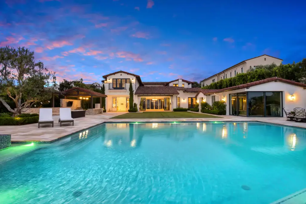 Backyard of luxury property sold by the best real estate agents in Newport Beach, with pool and outdoor living areas