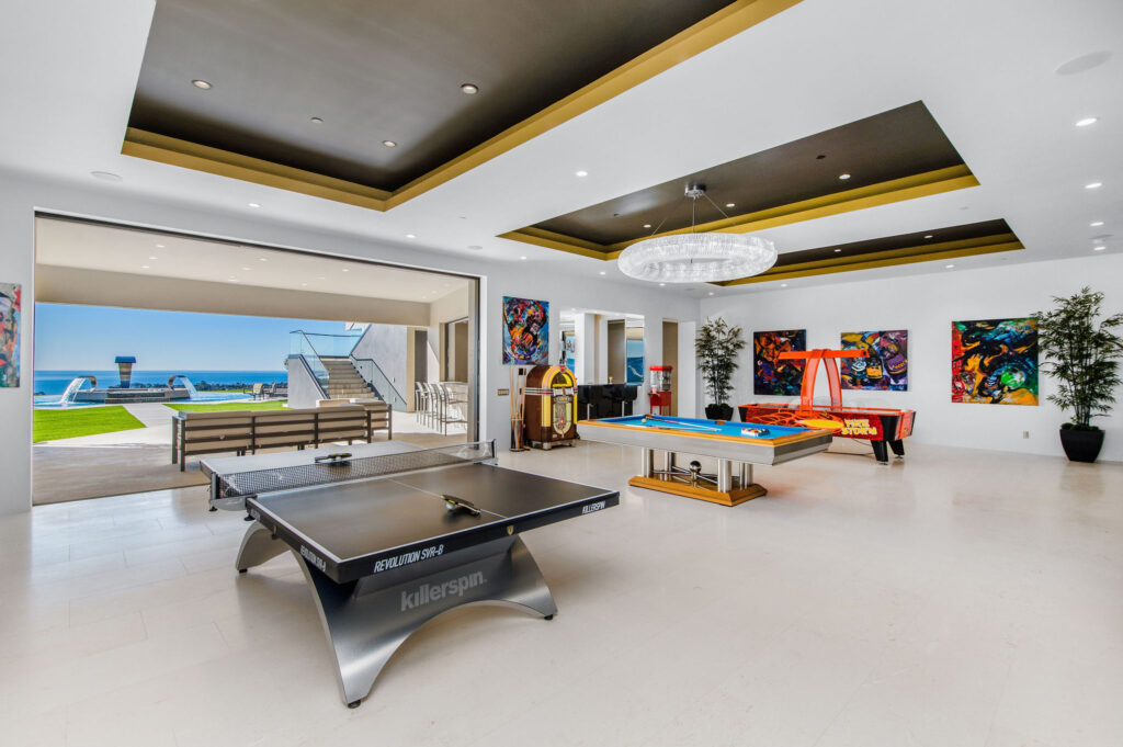 Game room of OC luxury property with pool and ping pong tables