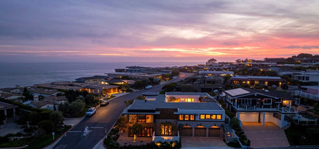 Aerial view of Monarch Bay homes with the sunset over the ocean in the background