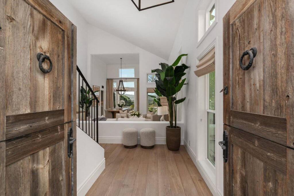 Double doors open to vaulted living area of luxury home