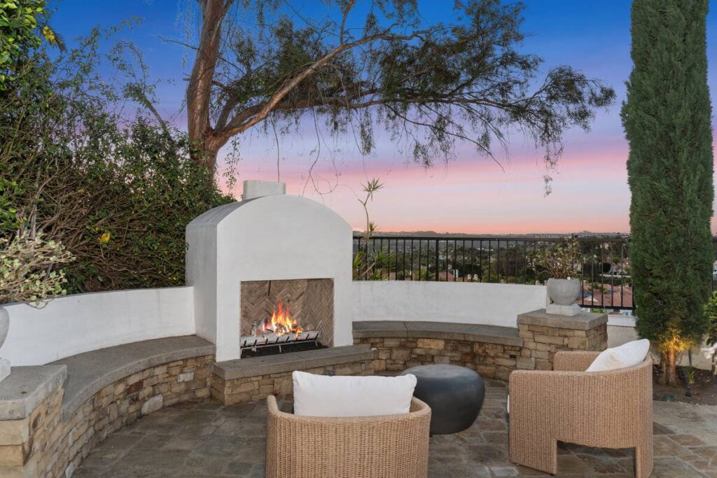 Outdoor fireplace backing to views in Laguna Niguel in a luxury home sold by the best real estate agents Stavros Group OC Realtors