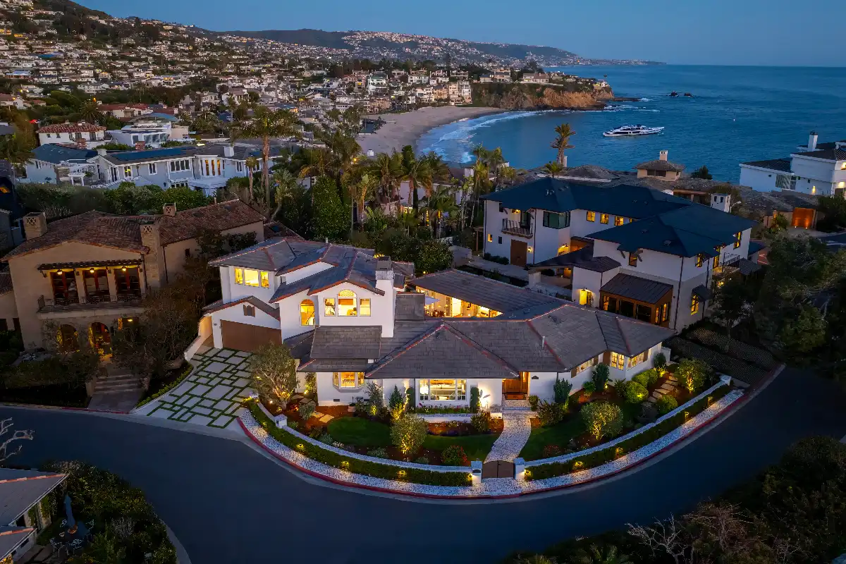 Aerial photo at dusk of a Laguna Beach property listed by The Stavros Group and Andy Stavros, the best real estate agents for selling a luxury home in Orange County