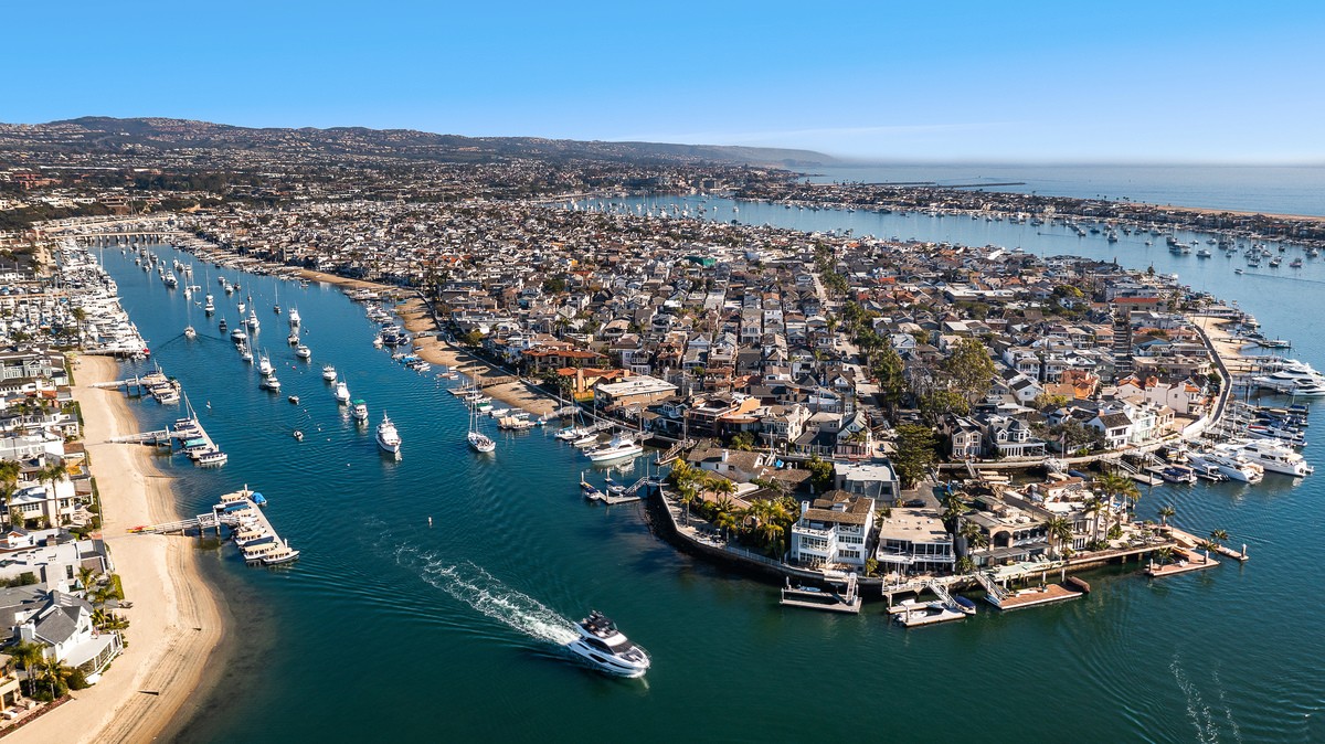 Aerial view of Balboa Island and Collins Island with Newport Beach Bayfront Homes for Sale