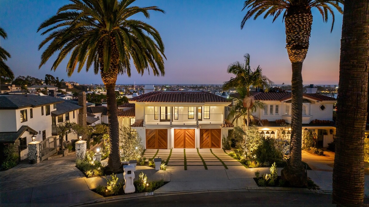 Front exterior of luxury property in Newport Beach at dusk with ocean views in distance, representing smart preparations before you sell your home