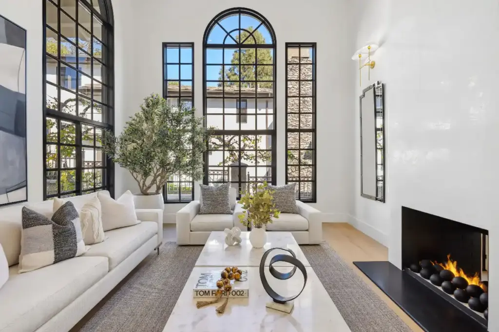 Living room with fireplace featuring professional photography and effective marketing strategies for luxury real estate by the best Newport Beach Realtor agent team, Andy Stavros Group