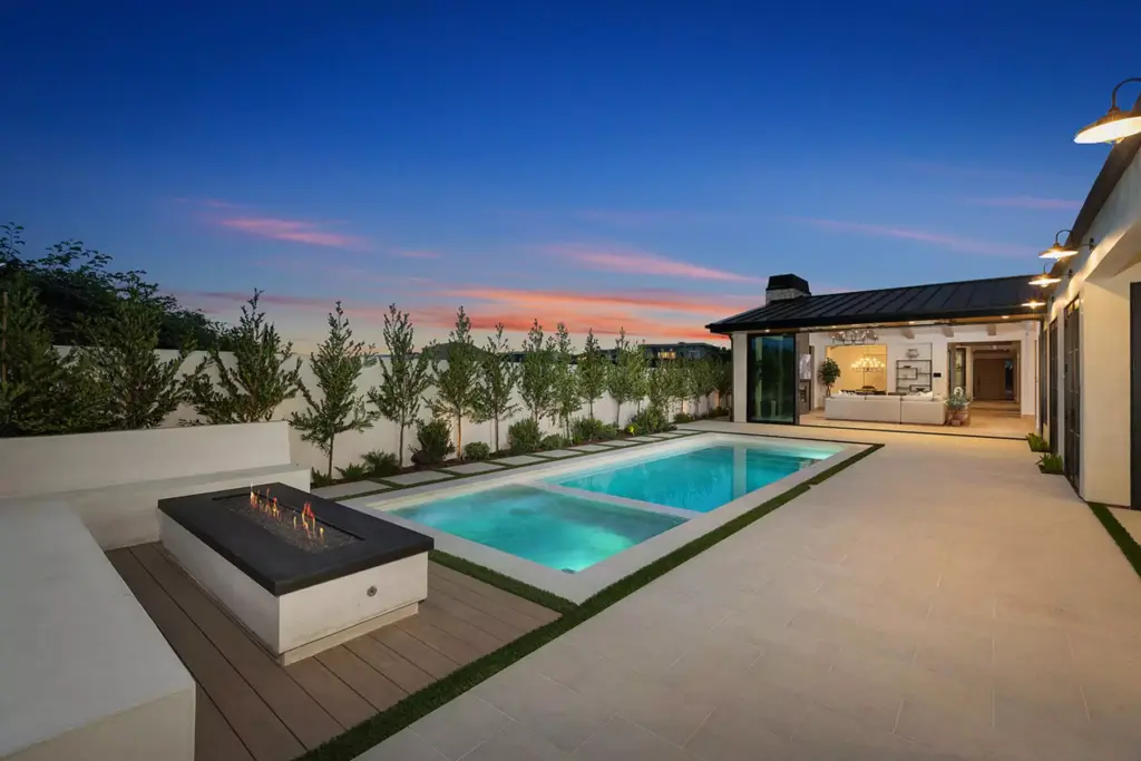 Backyard pool at dusk of a luxury Orange County home sold by the best Realtors for high-end properties and sellers agents