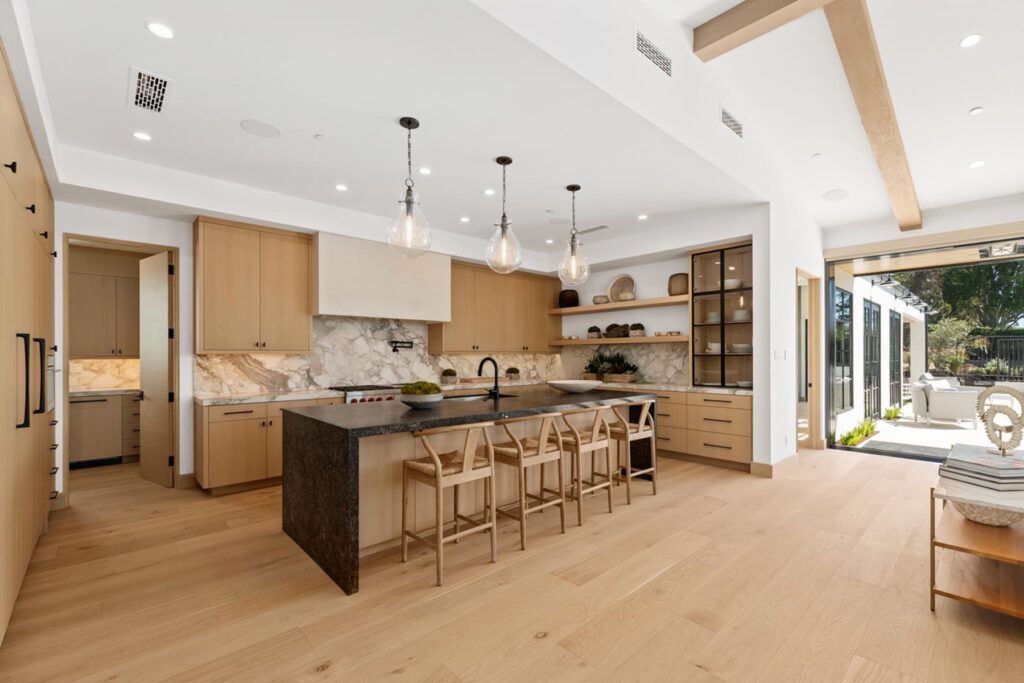Kitchen with luxurious island and outdoor living attached, sold by the best top luxury listing agent in coastal Orange County cities like Newport Beach, Laguna Beach, Corona del Mar, and Dana Point