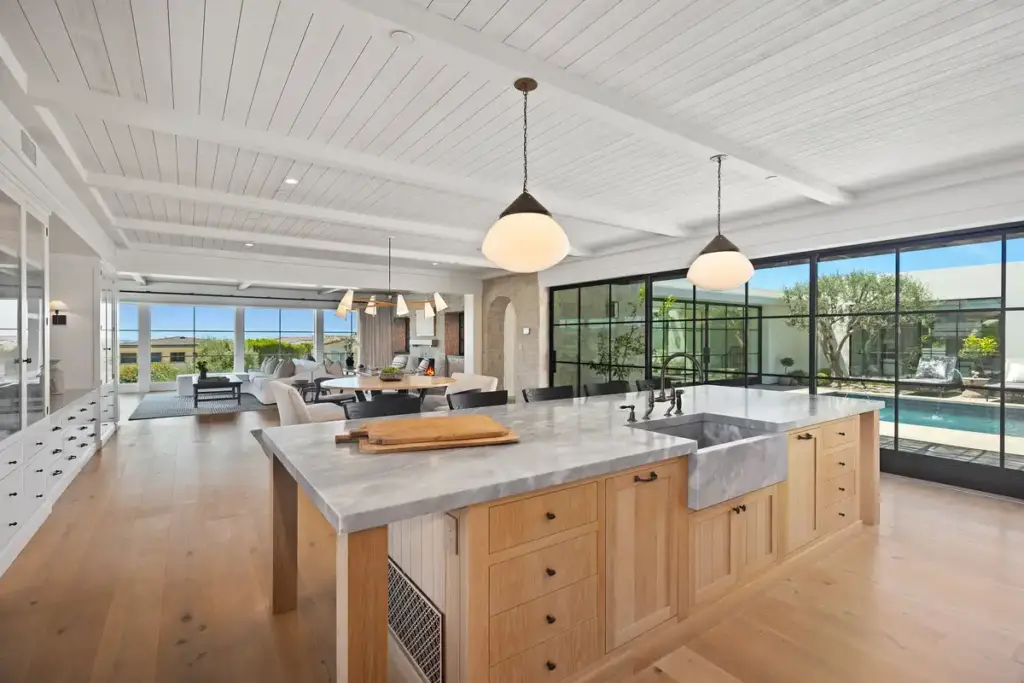 Open concept kitchen with large island in a private or public real estate listing by the Stavros Group best luxury listing agents