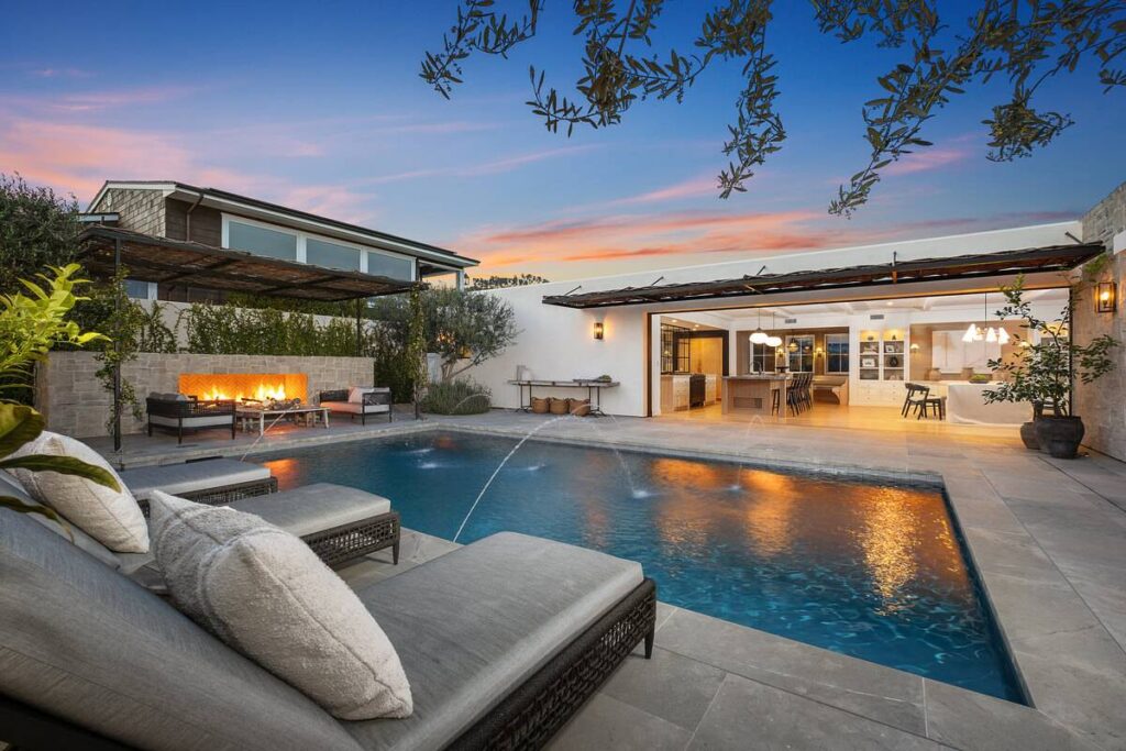 Backyard pool with bifold doors to interior living area at a luxury home represented by Dana Point’s top luxury real estate agent Andy Stavros