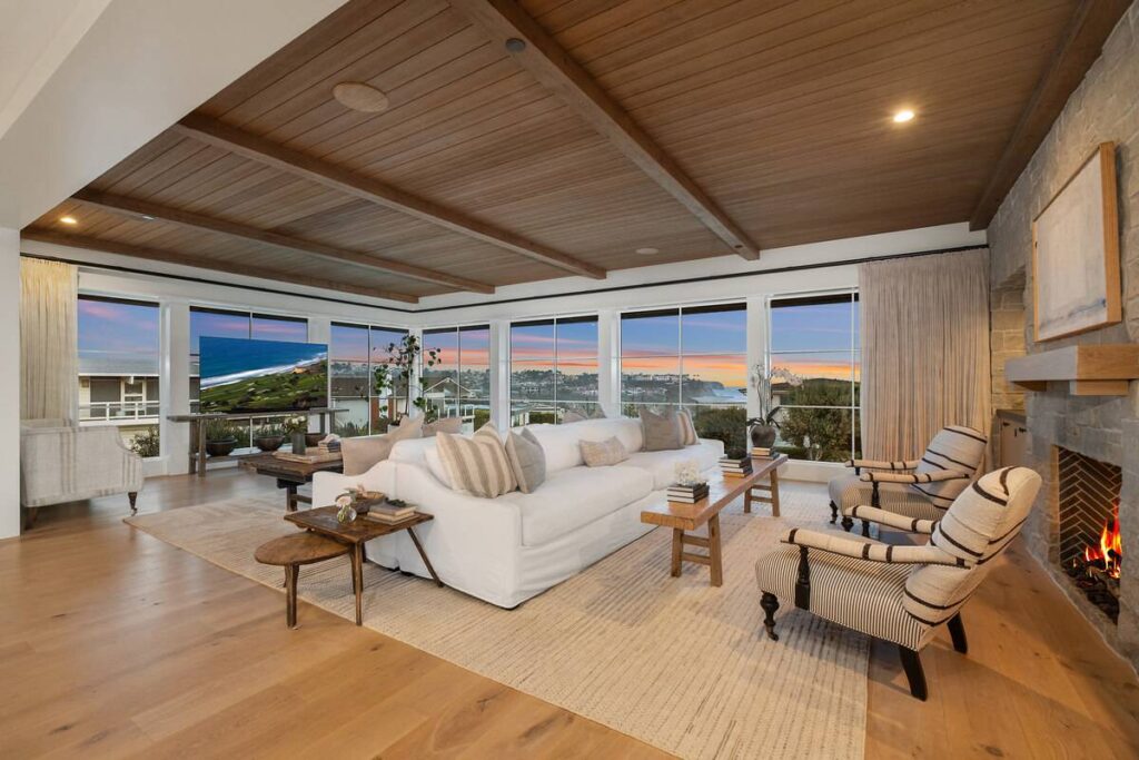 Living room of a Monarch Bay home at dusk with sunset colors above ocean views in Dana Point